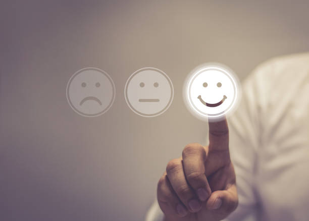 A customer selecting a smiling face on a service rating screen